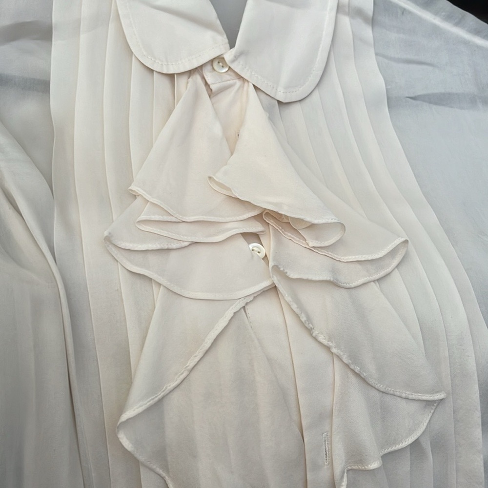 Beautiful blouse worn under jacket once. 100% silk. Off white, tan in color.